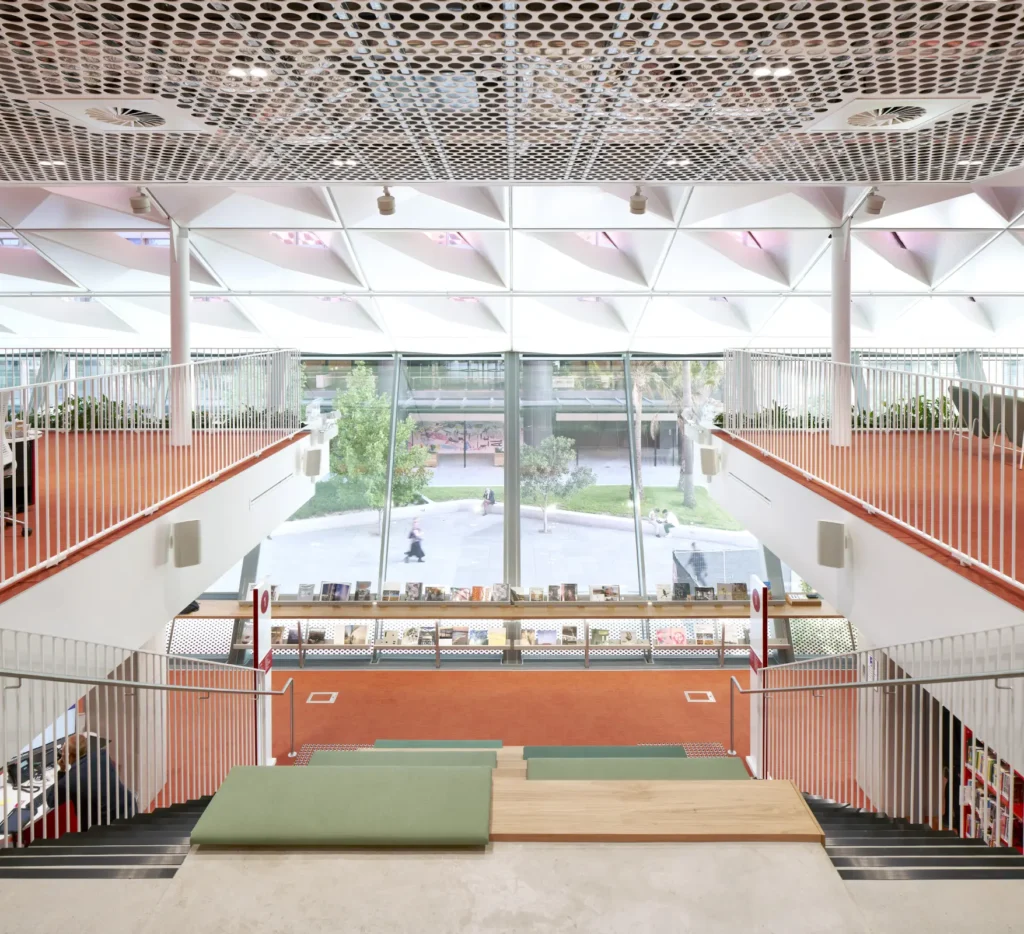 Multi-level atrium with stair seating and orange carpet at PHIVE Community Center