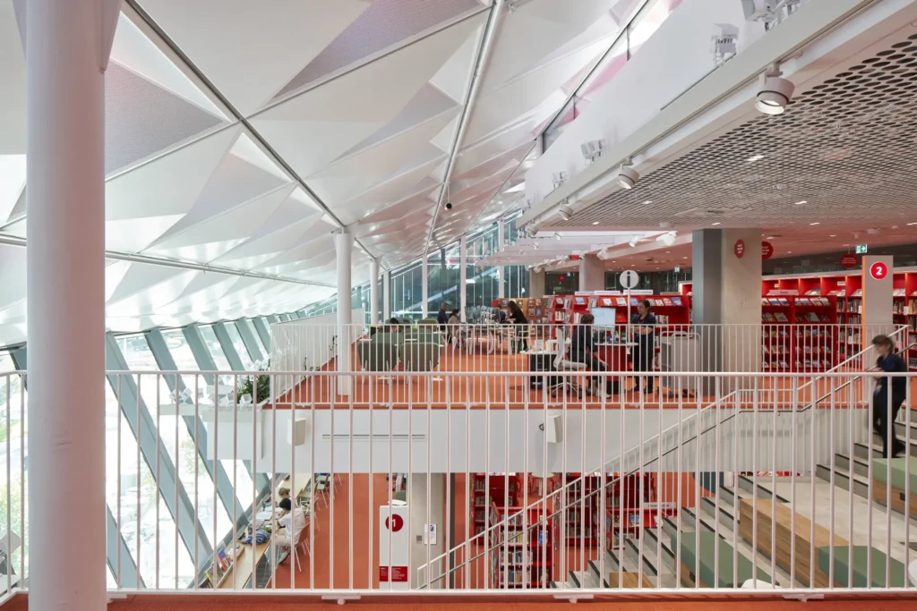 Reading area with bench seating and city views at PHIVE by Manuelle Gautrand Architects