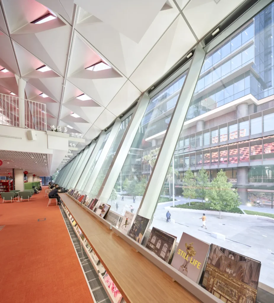 Open-plan library floor with reading desks and city views at PHIVE Community Center in Parramatta, Sydney