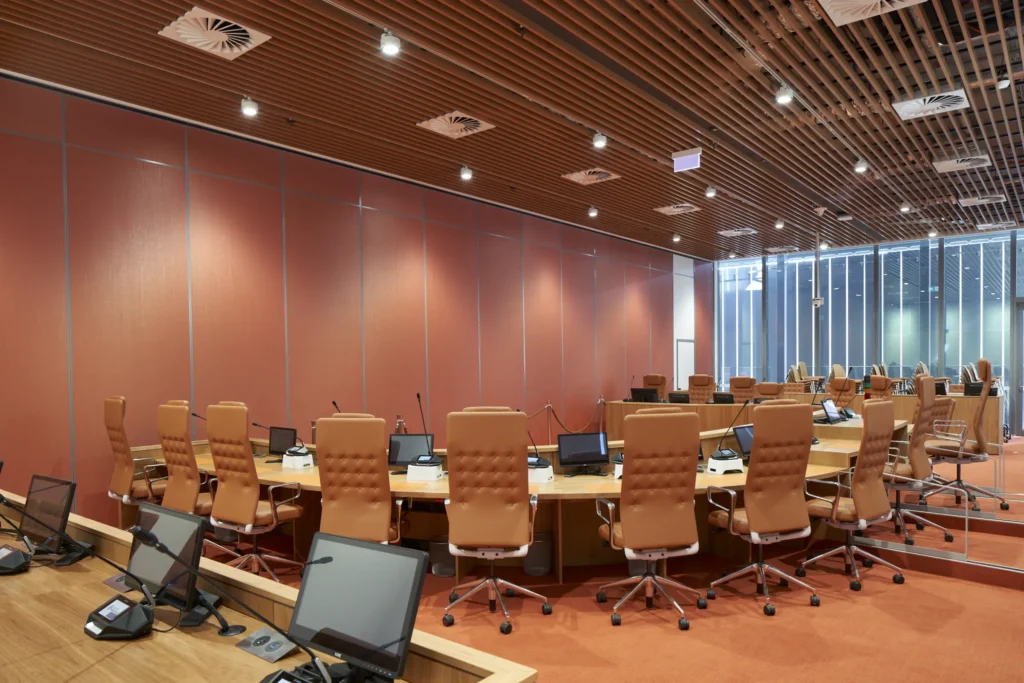 Council chambers with curved timber desk and leather chairs at PHIVE Parramatta