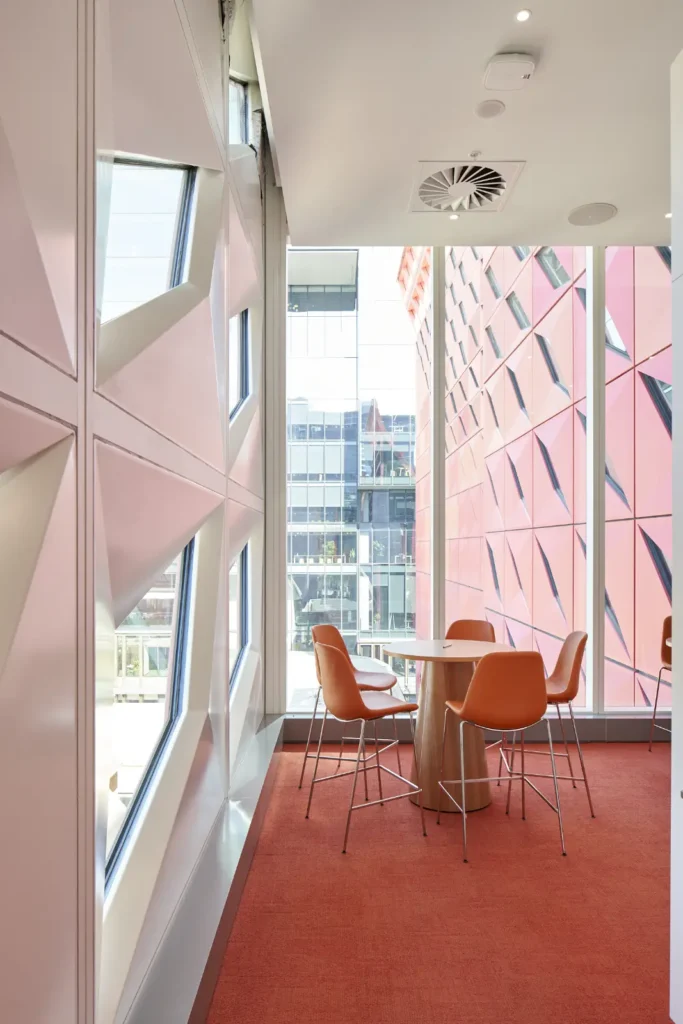 Meeting corner with red carpet and angular windows at PHIVE Community Center Parramatta