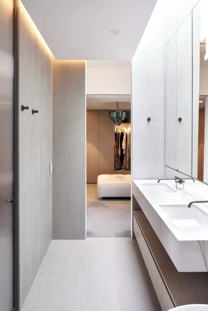 Luxury bathroom with stone finishes, heated towel rail and skylight at Alexandra Street Melbourne