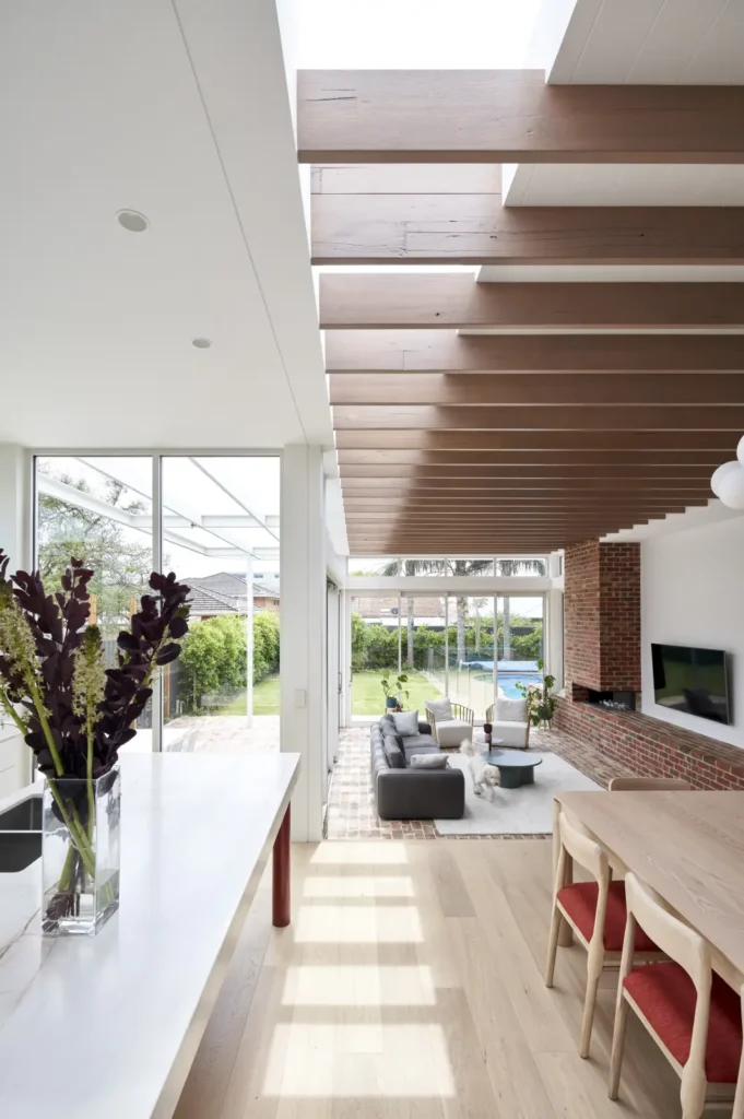View from interior through full-height glazing to garden and pool at Lindsay house Melbourne