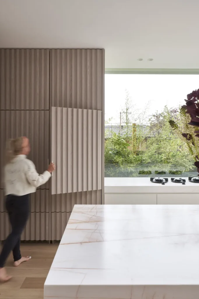 Kitchen with red marble and light oak material palette detail at Lindsay house