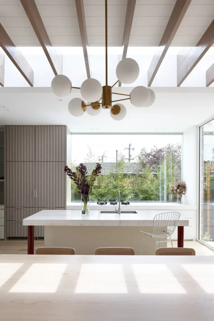 Open kitchen and dining space with skylight and oak joinery at Lindsay renovation