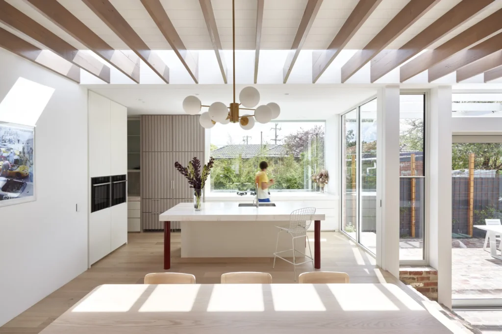 person in the open kitchen and dining space with light oak joinery at Lindsay renovation