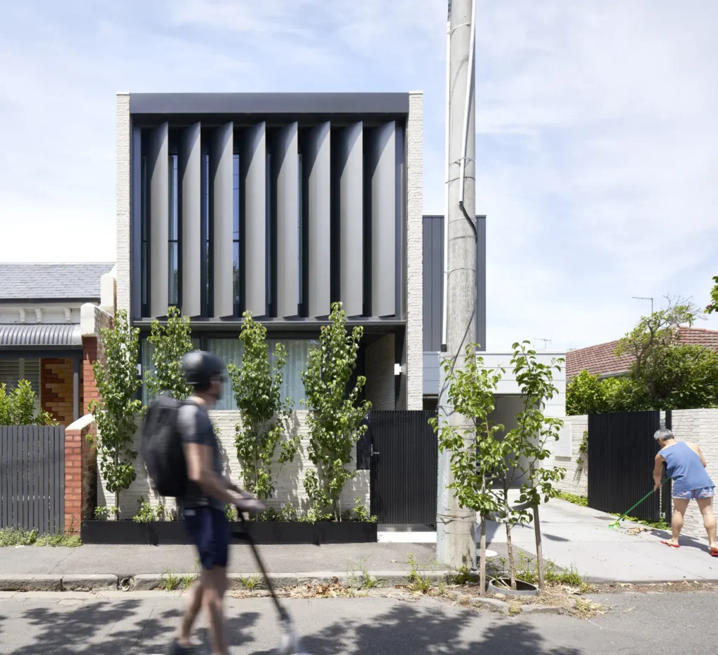 Alexandra Street house facade with pedestrian passing on South Yarra streetscape