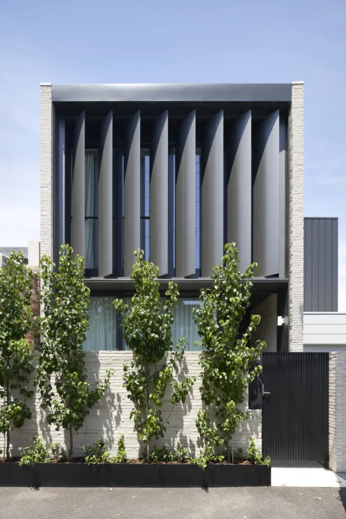 Dark metal louver facade of Alexandra Street house in South Yarra by Megowan Architectural