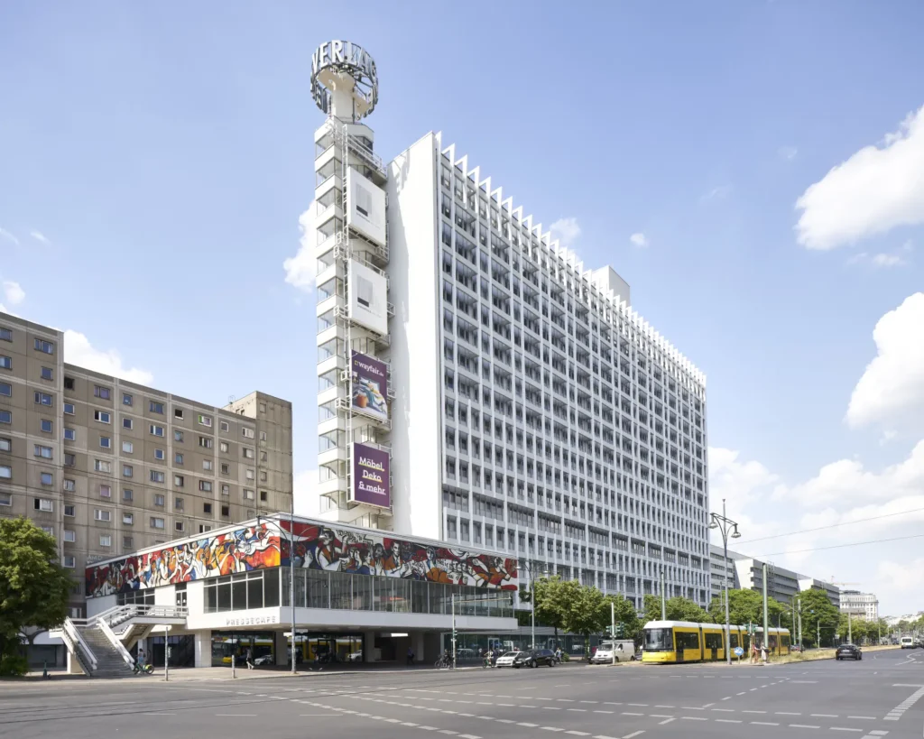 Willi Neubert frieze on Pressecafé with new glass facade behind at Alexanderplatz