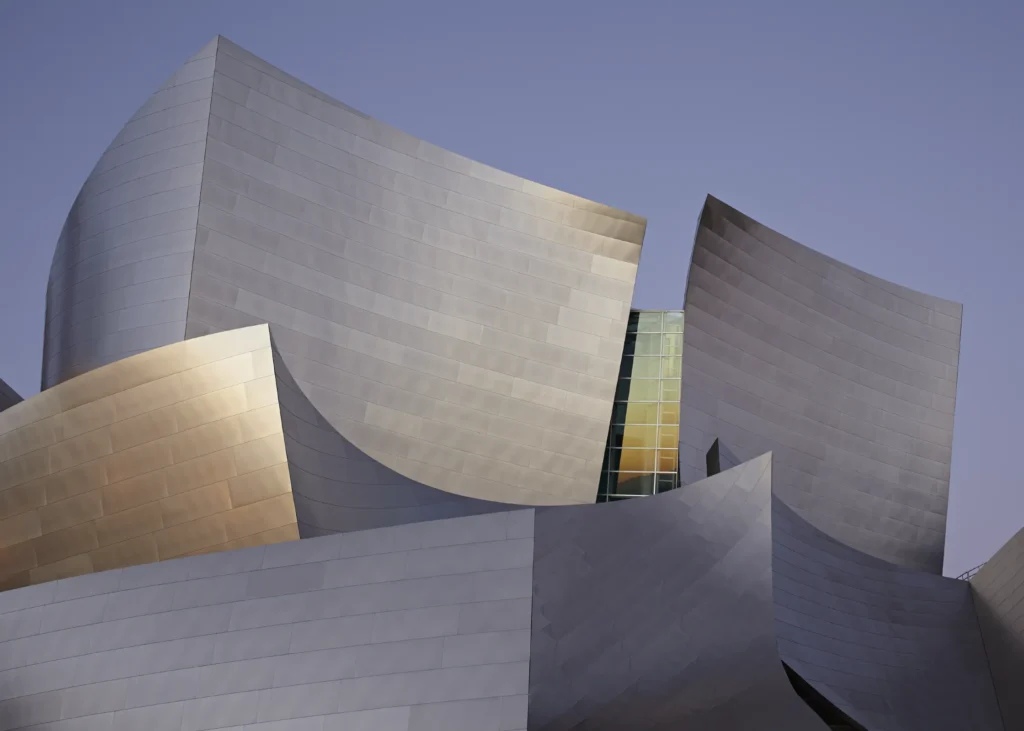 Stainless steel forms of Walt Disney Concert Hall with illuminated lobby below