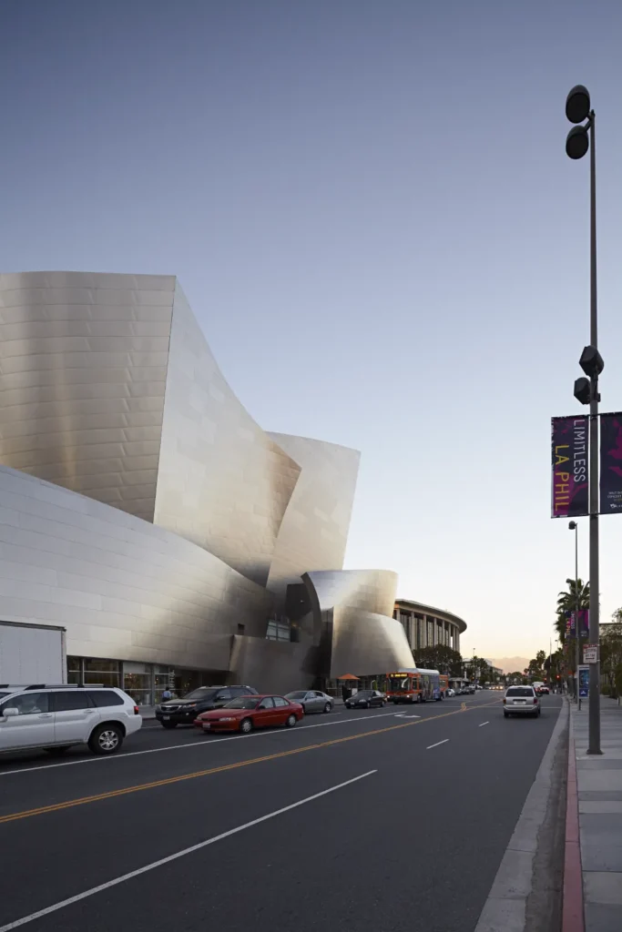 Walt Disney Concert Hall with cars in golden hour light in Los Angeles