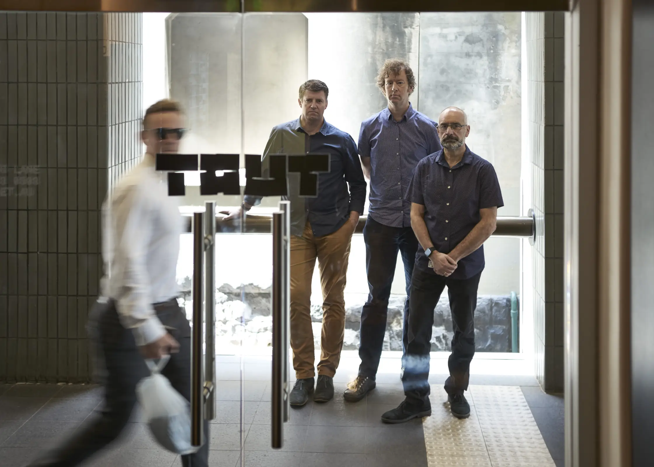 TAUT Studio team Melbourne portrait viewed through glass in laneway