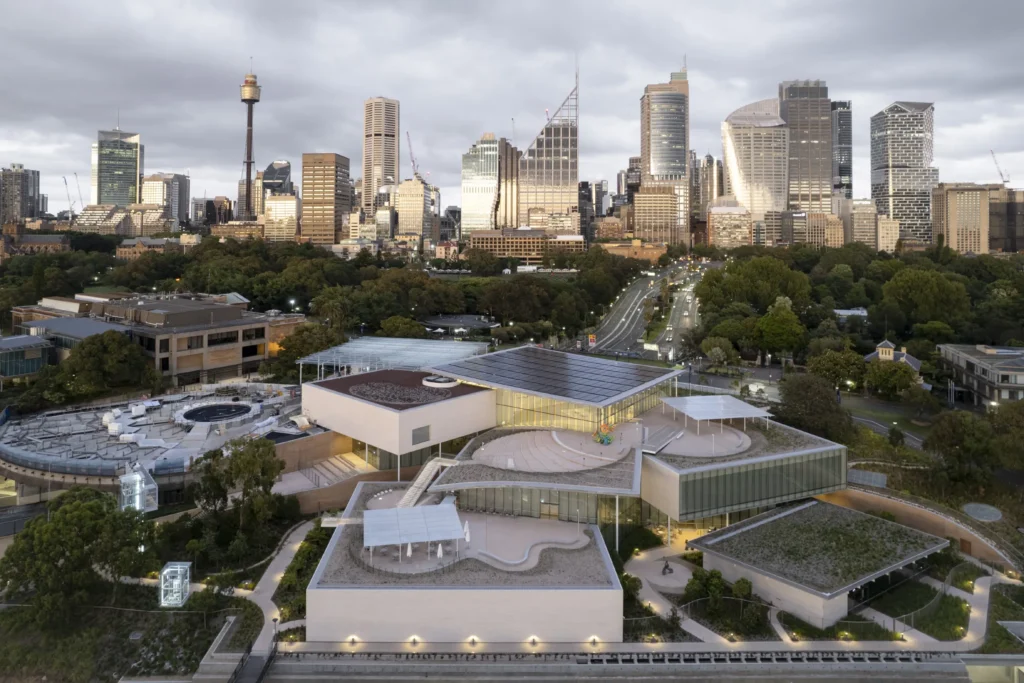 Aerial view of Sydney Modern art gallery extension showing the connected glass pavilions against the Skyline backdrop