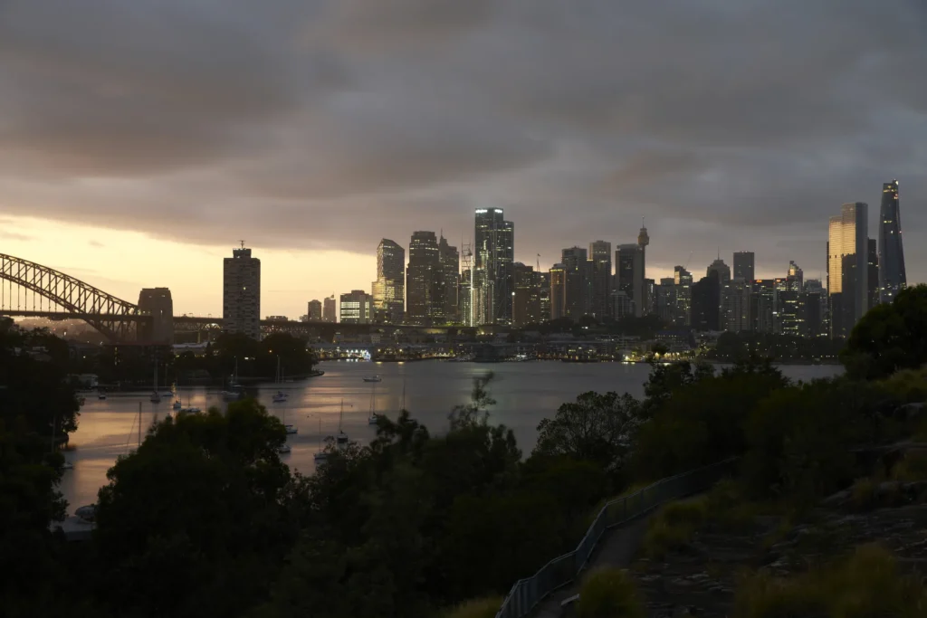 Dramatic sky in front of Sydney harbour bridge with Quay Quarter Tower among the CBD high-rises