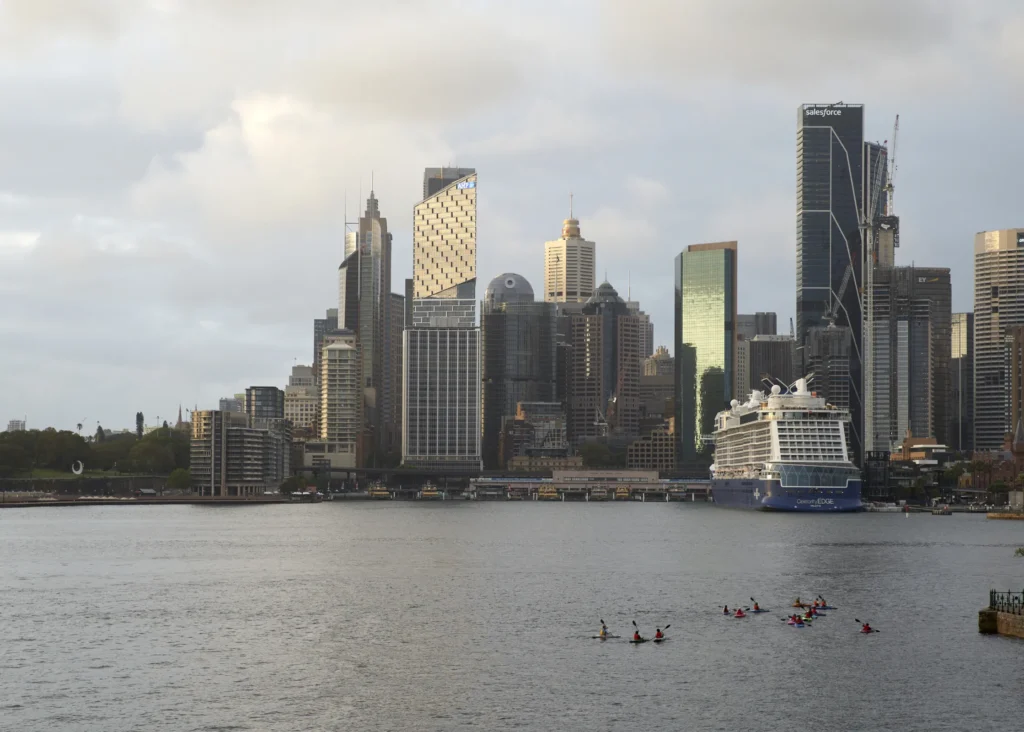 Sydney harbour skyline with Quay Quarter Tower among the CBD high-rises and kayak tour in the bay