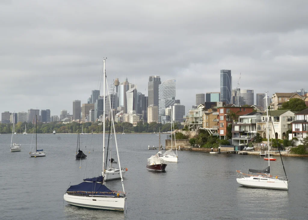 Boats and houses at Kurraba Point looking across to Sydney CBD and Quay Quarter tower