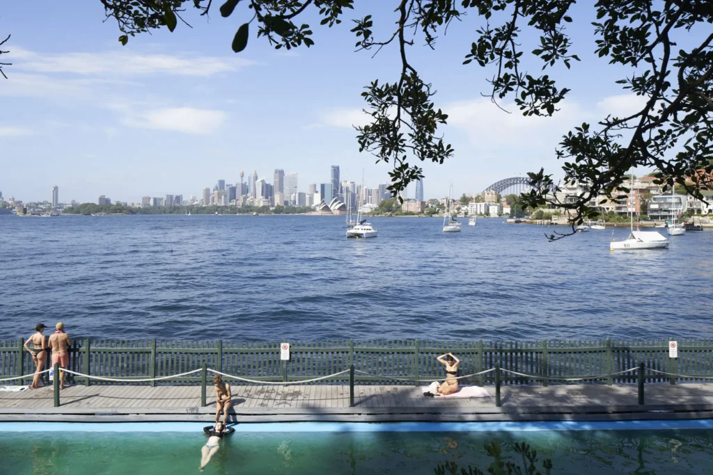 Outdoor swimming pool with Sydney harbour and CBD skyline in the background