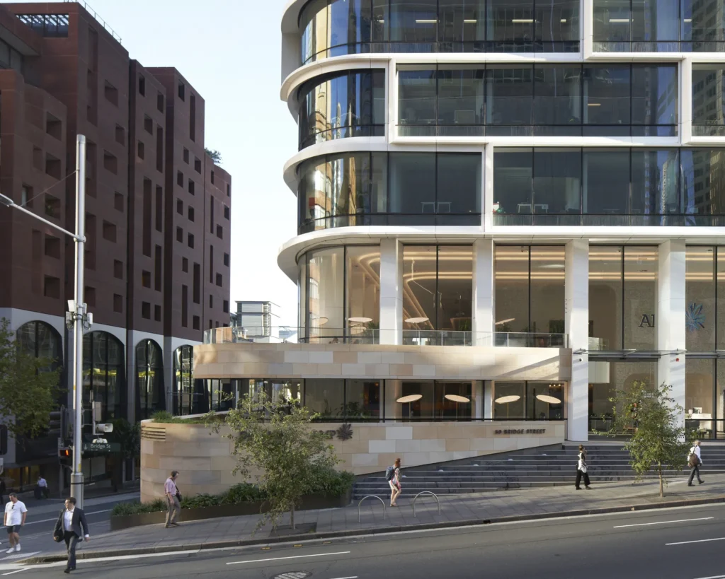 Stacked curved glass floors showing the volumetric shift of the Quay Quarter Tower's main entrance