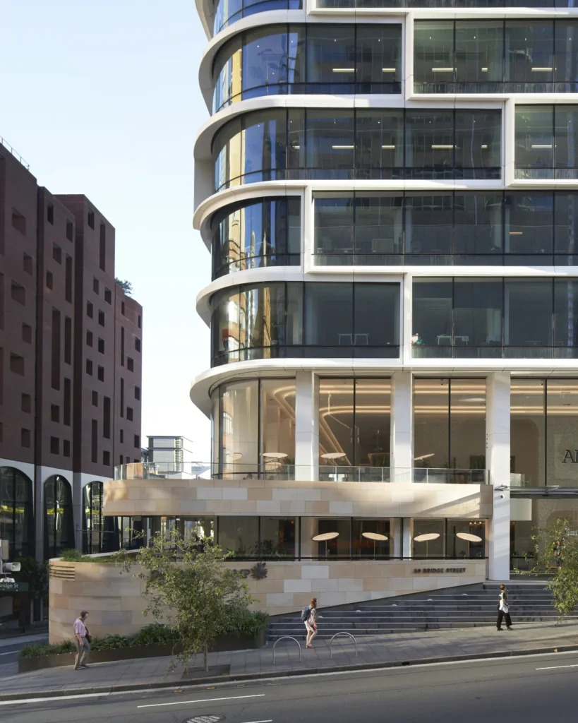 Stacked curved glass floors showing the volumetric shift of the Quay Quarter Tower's main entrance