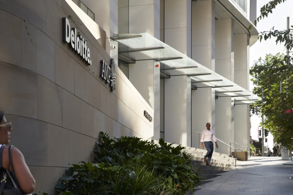 Street-level entrance of Quay Quarter Tower with pedestrians on stairs