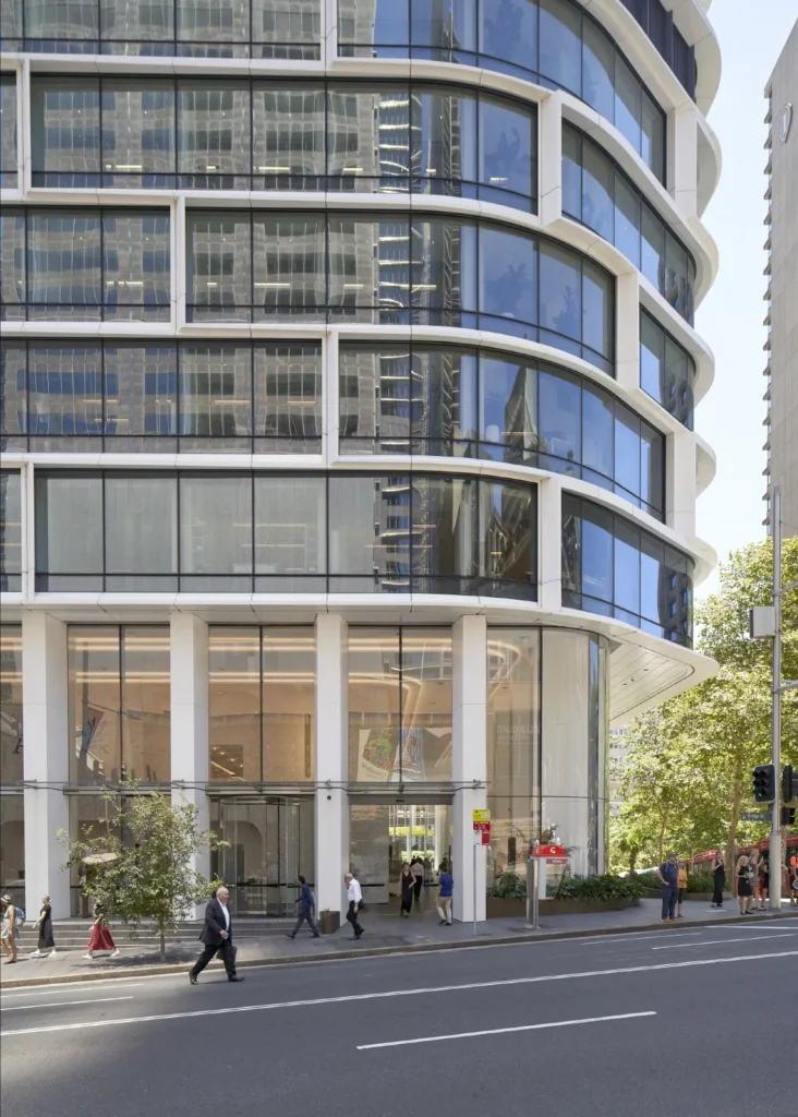 Curved glass facade of Quay Quarter Tower podium by 3XN Architects and BVN Architecture in Sydney